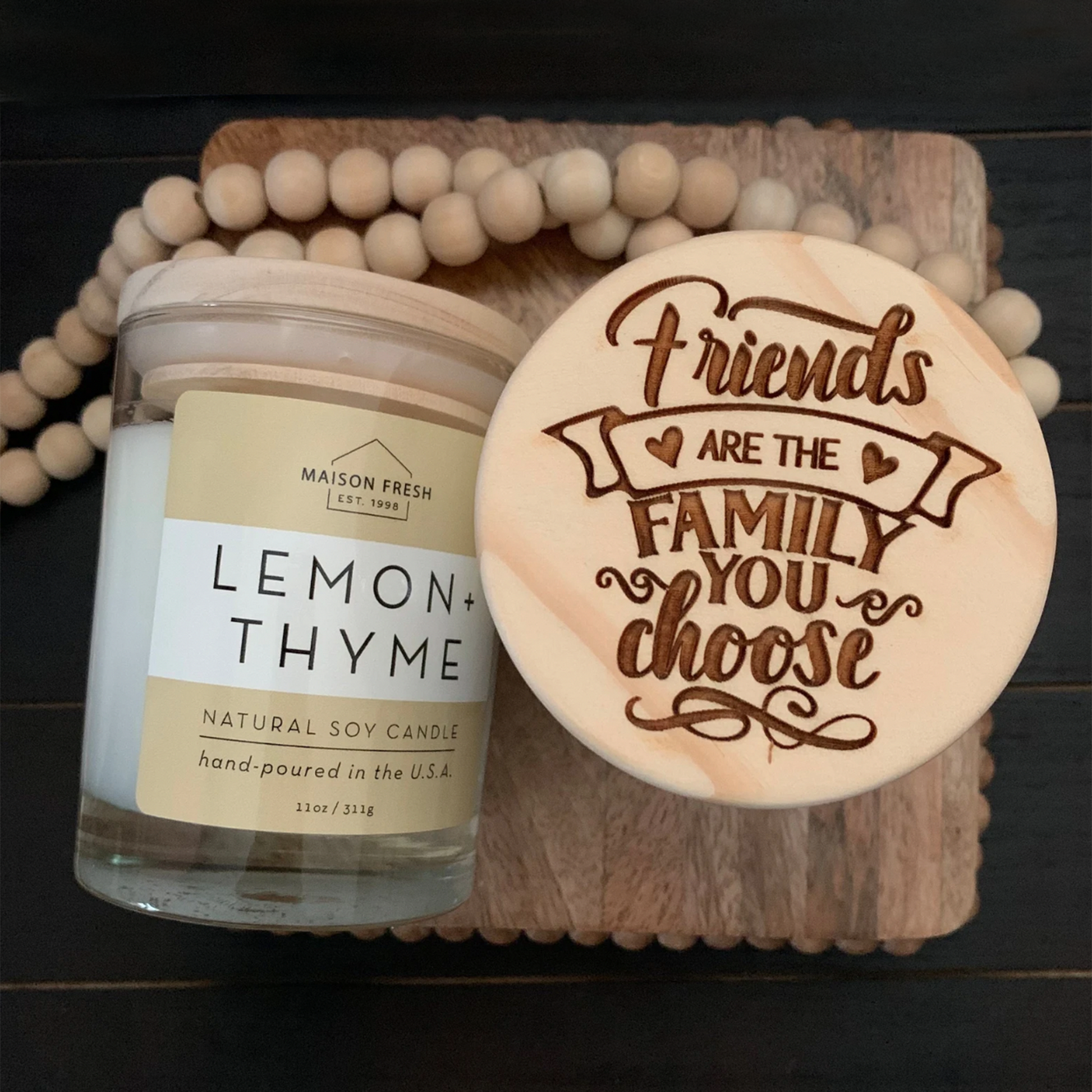 scented candle with engraved message  on wood top friends are the family you choose